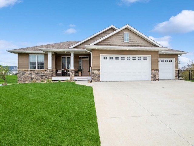 craftsman-style home with stone siding, an attached garage, a porch, and concrete driveway