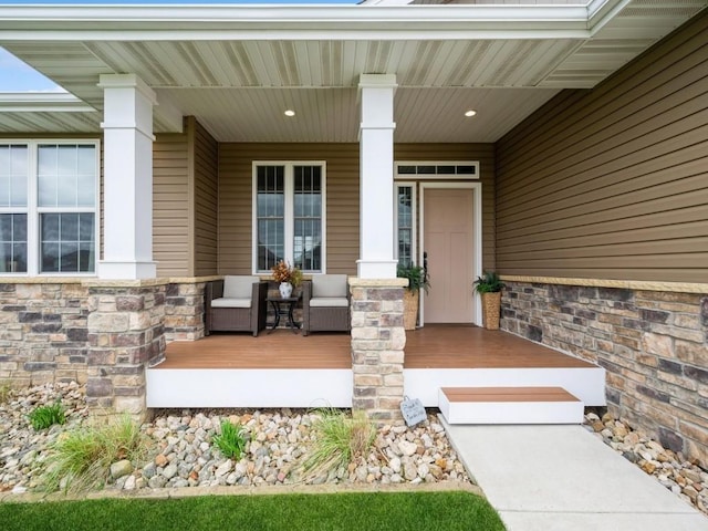 property entrance with a porch and stone siding