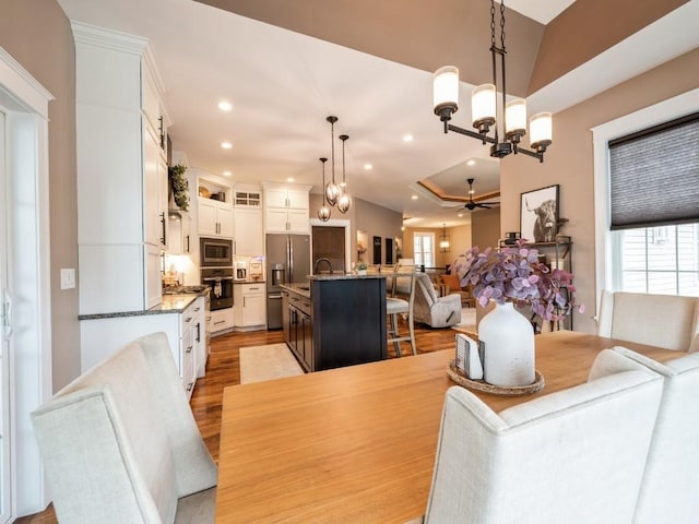dining space featuring a chandelier, recessed lighting, light wood finished floors, and a ceiling fan