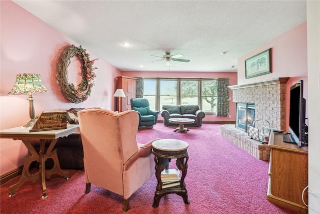 living area with carpet flooring, ceiling fan, a textured ceiling, a fireplace, and recessed lighting