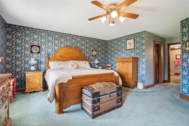 carpeted bedroom featuring wallpapered walls, baseboards, and a ceiling fan