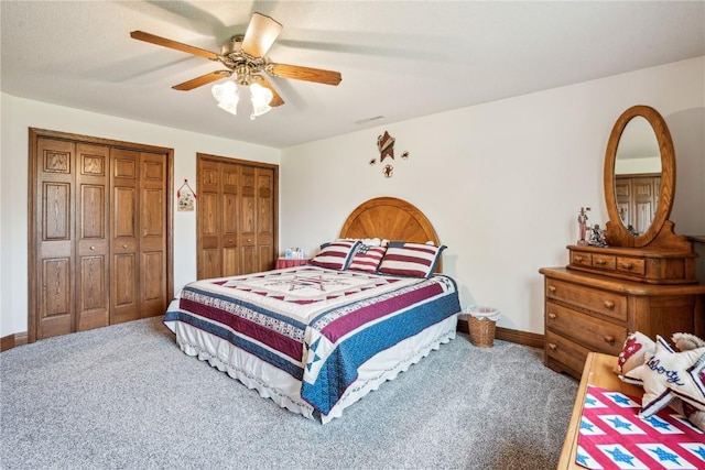 4030 Bruce Rd, Marion, IA 52302 - carpeted bedroom featuring multiple closets, baseboards, and a ceiling fan