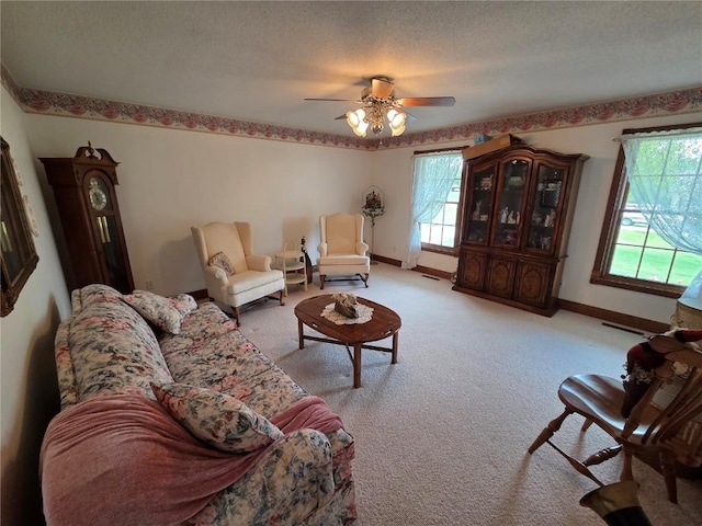 4030 Bruce Rd, Marion, IA 52302 - living area featuring plenty of natural light, light carpet, baseboards, a ceiling fan, and a textured ceiling