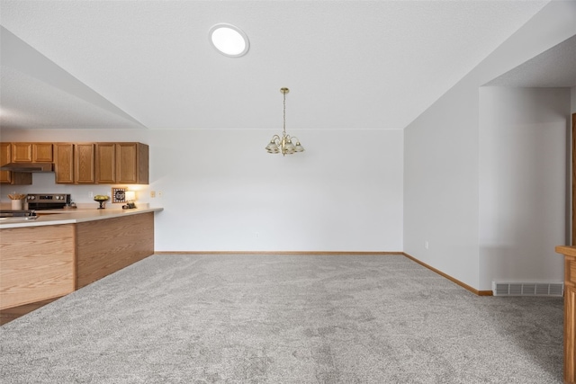 kitchen with carpet flooring, under cabinet range hood, and baseboards