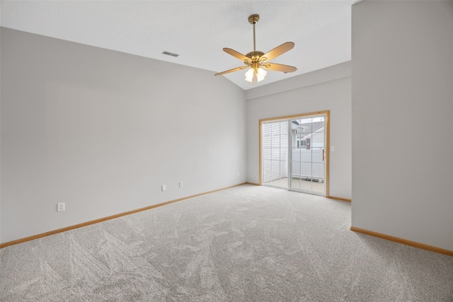 carpeted empty room with baseboards, a ceiling fan, and vaulted ceiling