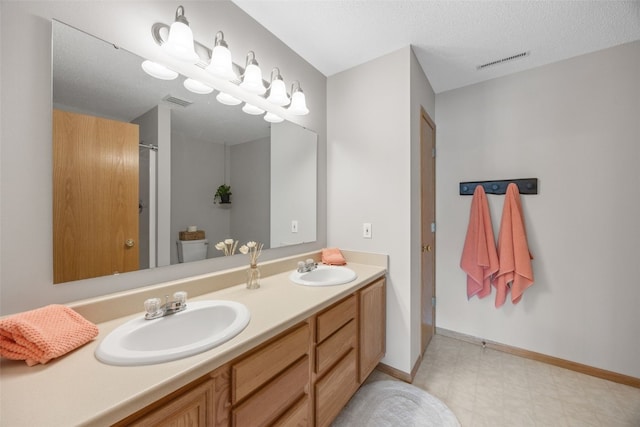 full bathroom featuring tile patterned floors, double vanity, and baseboards