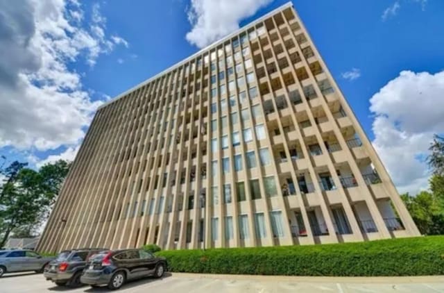 view of building exterior featuring uncovered parking