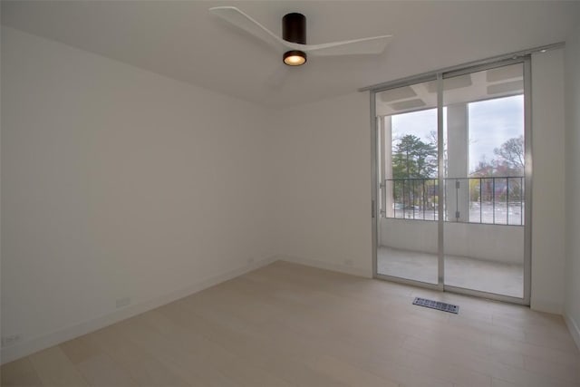 spare room featuring ceiling fan and baseboards