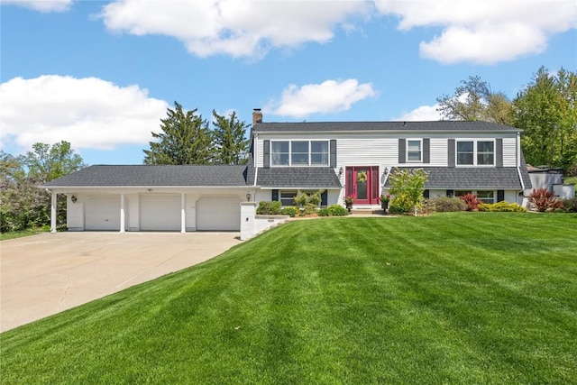 view of front of home with an attached garage, driveway, a front lawn, and a chimney