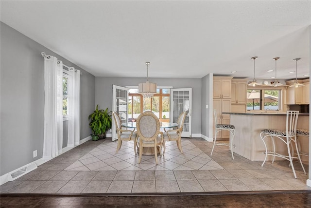 dining room featuring baseboards, light tile patterned flooring, a chandelier, and recessed lighting