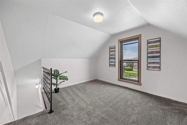 bonus room with carpet floors, vaulted ceiling, and baseboards