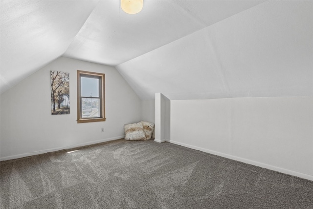 bonus room featuring vaulted ceiling, carpet flooring, and baseboards