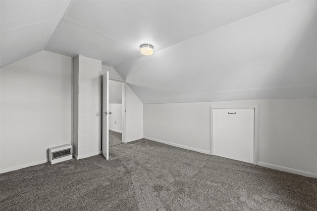 bonus room with carpet flooring, lofted ceiling, baseboards, and heating unit