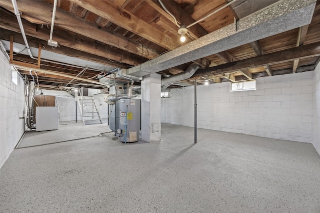 unfinished basement featuring water heater