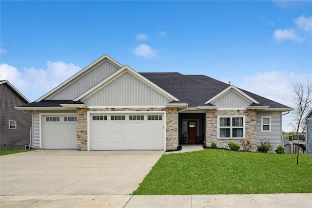 craftsman house featuring driveway, a garage, a front lawn, board and batten siding, and stone siding