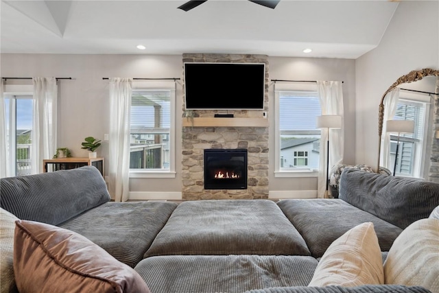 living area featuring baseboards, plenty of natural light, a fireplace, ceiling fan, and recessed lighting