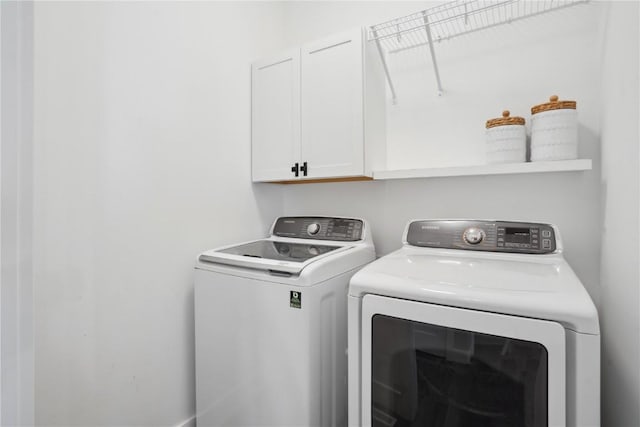 laundry room with cabinet space and separate washer and dryer