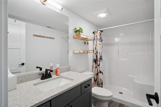 full bathroom featuring toilet, a shower with curtain, vanity, and wood finished floors