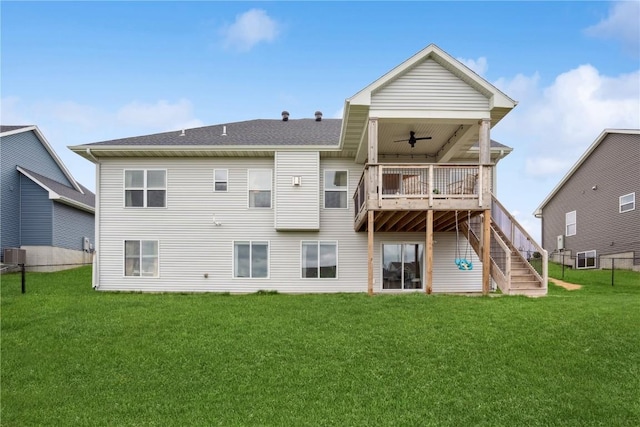 rear view of property with a ceiling fan, stairway, a lawn, and cooling unit