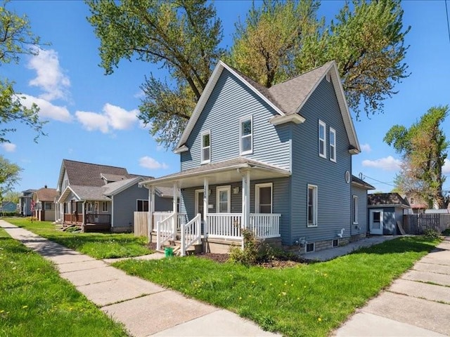 view of front of home with covered porch and a front lawn