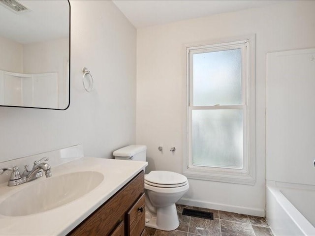 full bathroom with vanity, toilet, baseboards, a tub, and a shower
