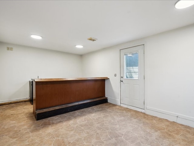 bar with baseboards, stone finish flooring, and recessed lighting