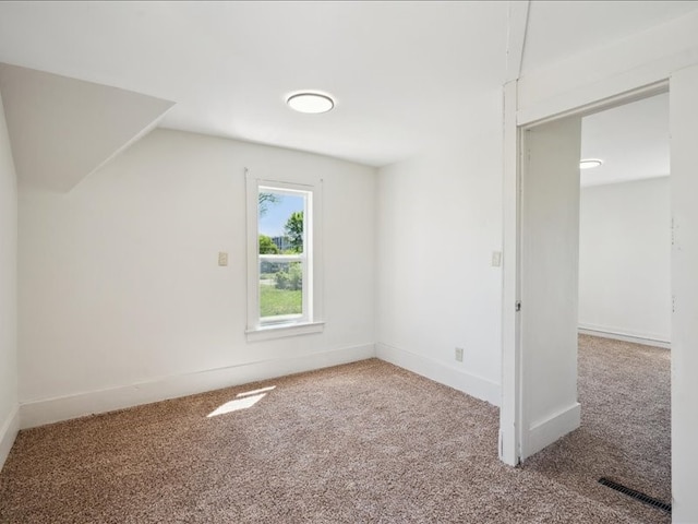 additional living space featuring carpet flooring, baseboards, and lofted ceiling