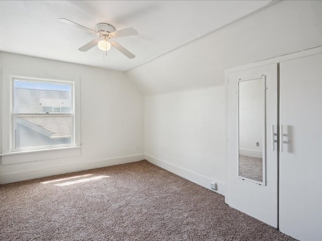 additional living space featuring carpet, lofted ceiling, ceiling fan, and baseboards