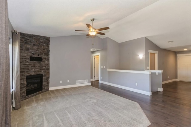 unfurnished living room with ceiling fan, vaulted ceiling, baseboards, wood finished floors, and a fireplace