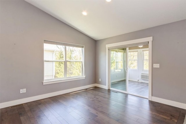 unfurnished room featuring plenty of natural light, dark wood finished floors, baseboards, lofted ceiling, and recessed lighting