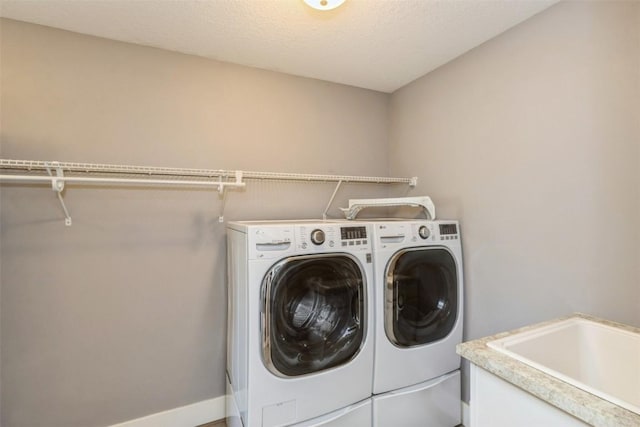 laundry room with washer and clothes dryer and baseboards