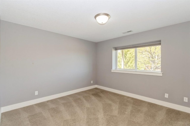 unfurnished room with carpet flooring and baseboards