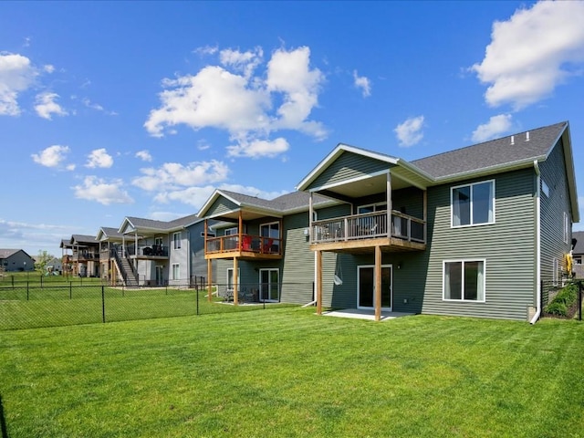 rear view of property featuring a balcony and a patio area