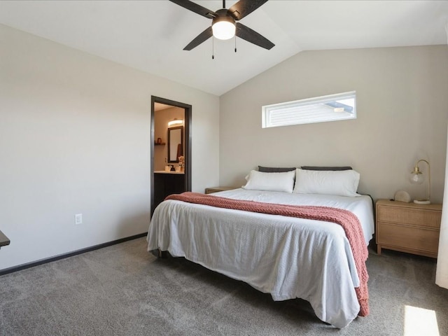 bedroom featuring carpet floors, lofted ceiling, ensuite bathroom, and a ceiling fan