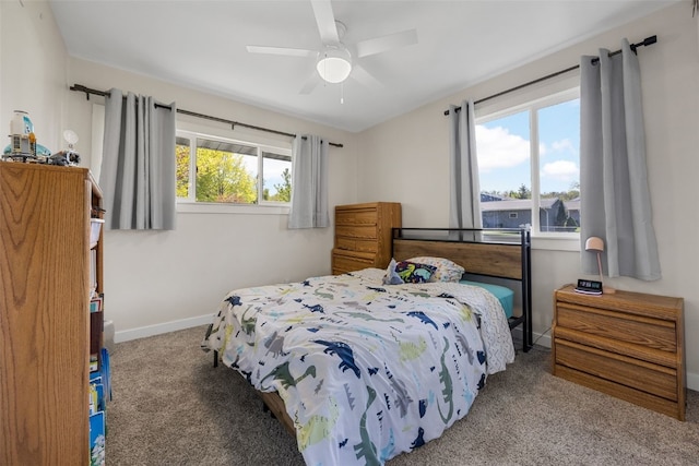 carpeted bedroom featuring baseboards and a ceiling fan