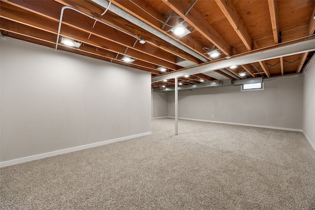 basement featuring carpet floors and baseboards