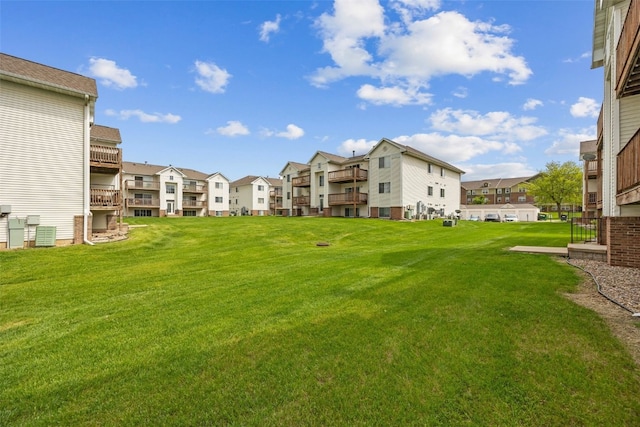 view of property's community featuring a residential view and a yard