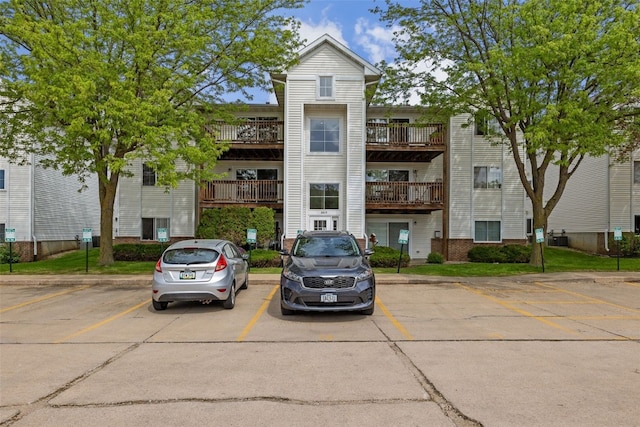 view of building exterior featuring uncovered parking