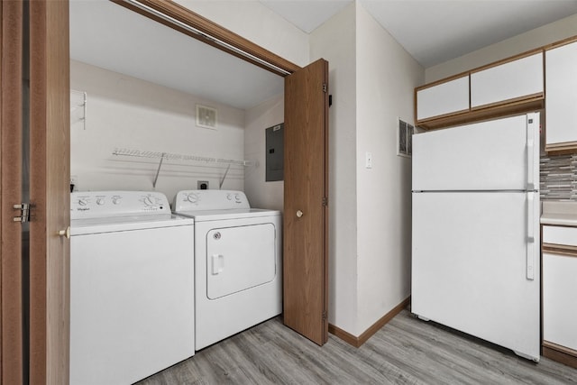 4619 1st Ave SW Unit 3, Cedar Rapids, IA 52404 - laundry room featuring washer and dryer, light wood finished floors, electric panel, and baseboards