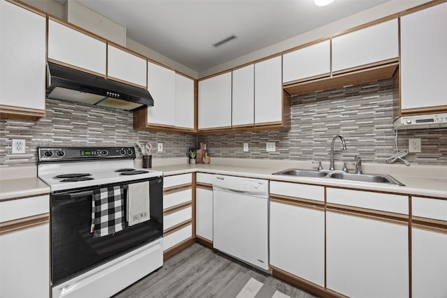 kitchen with range with electric stovetop, under cabinet range hood, white dishwasher, a sink, and light countertops