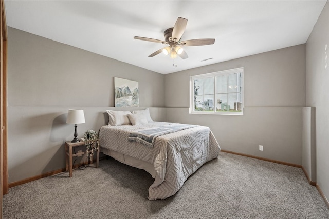 carpeted bedroom featuring baseboards and ceiling fan