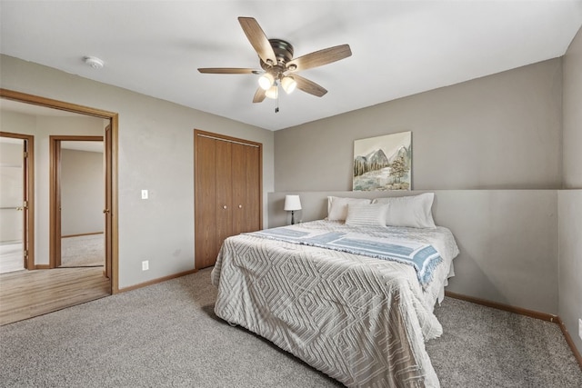 carpeted bedroom with baseboards, a closet, and ceiling fan