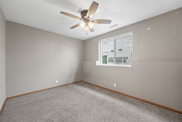 unfurnished room with carpet flooring, baseboards, and a ceiling fan