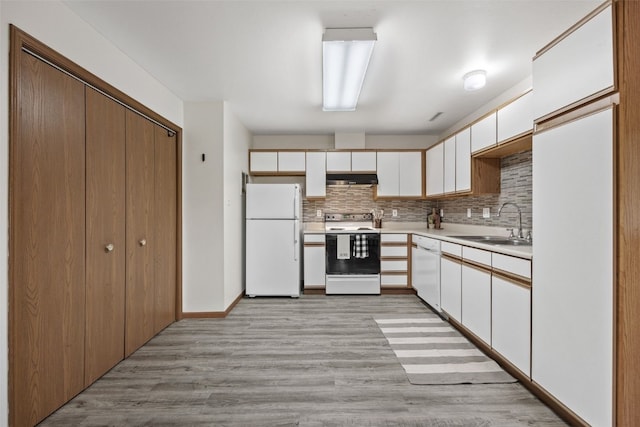 4619 1st Ave SW Unit 3, Cedar Rapids, IA 52404 - kitchen featuring white appliances, a sink, light wood-type flooring, and light countertops