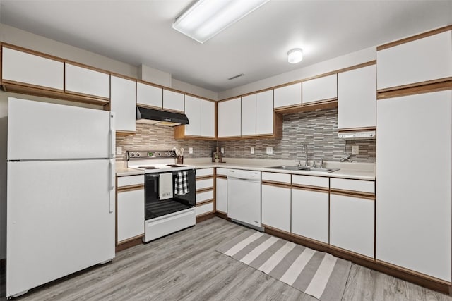 4619 1st Ave SW Unit 3, Cedar Rapids, IA 52404 - kitchen featuring white appliances, under cabinet range hood, a sink, white cabinetry, and light countertops