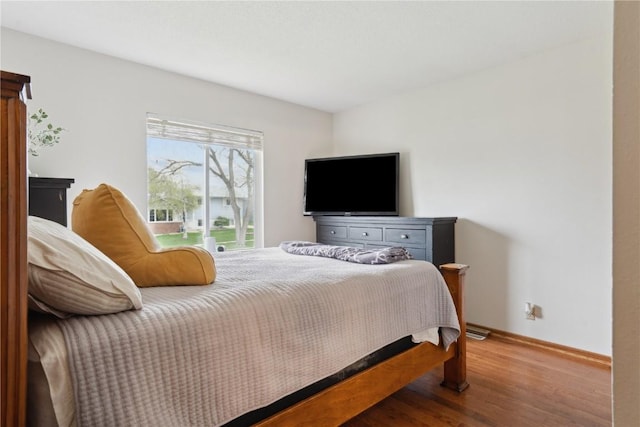 bedroom featuring wood finished floors and baseboards