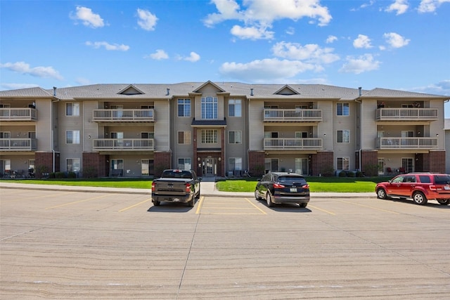 250 Cimarron Dr Unit 207, Hiawatha, IA 52233 - view of apartment building / complex with uncovered parking
