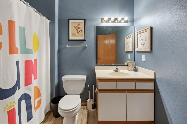 250 Cimarron Dr Unit 207, Hiawatha, IA 52233 - full bathroom featuring wood finished floors, toilet, vanity, and a shower with curtain