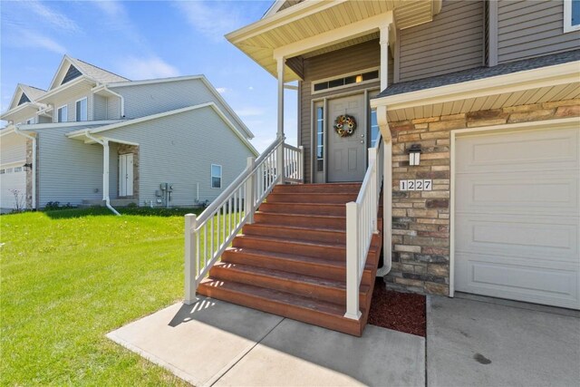 1227 Mary Ln, North Liberty, IA 52317 - view of exterior entry featuring a lawn and stone siding
