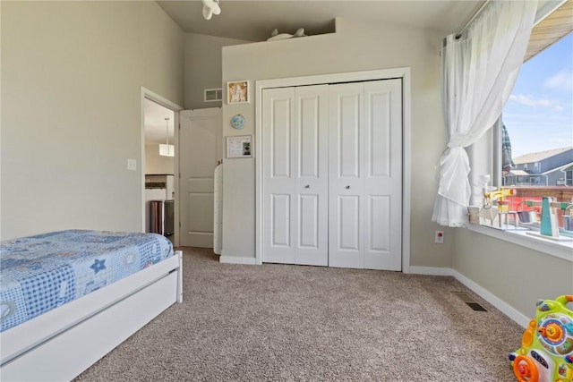 1227 Mary Ln, North Liberty, IA 52317 - bedroom featuring carpet floors, a closet, lofted ceiling, and baseboards